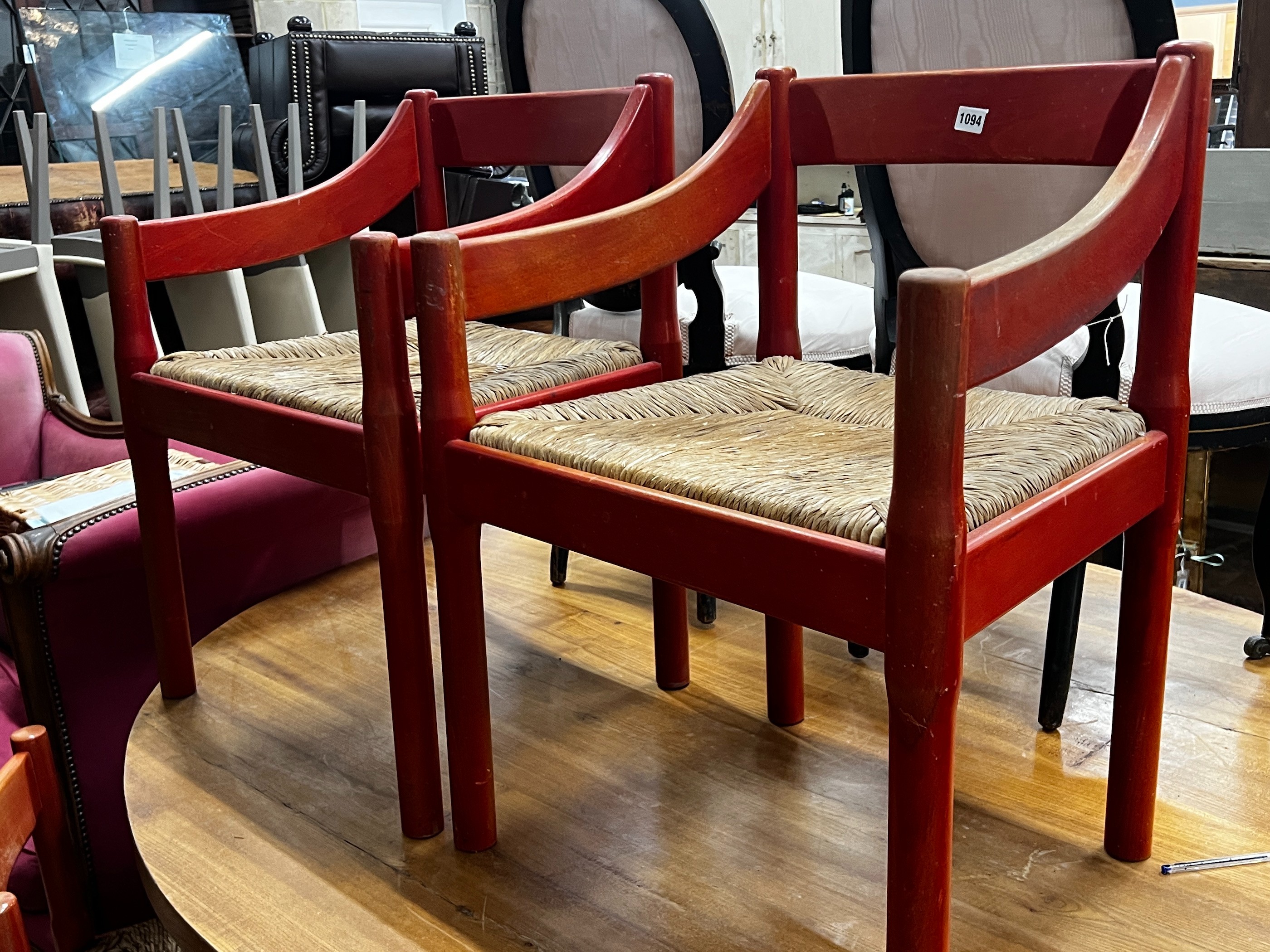 A set of four Magistretti Carimate chairs with rush seats